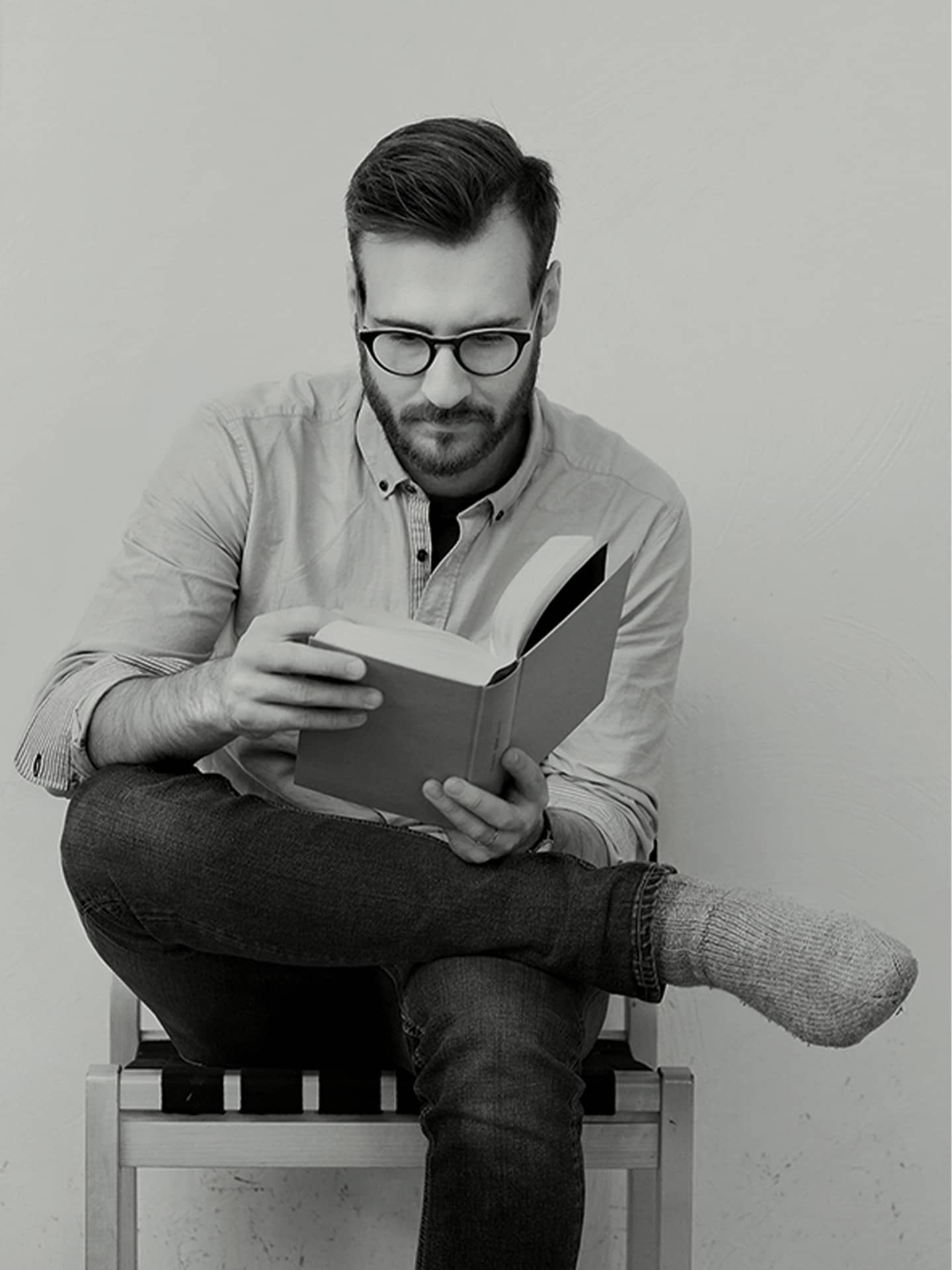 Academic bookstore brand imagery of man reading